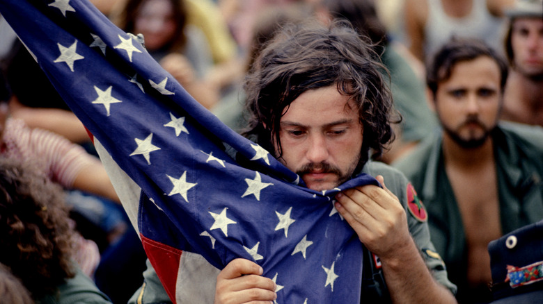 Vietnam War veteran clutching flag