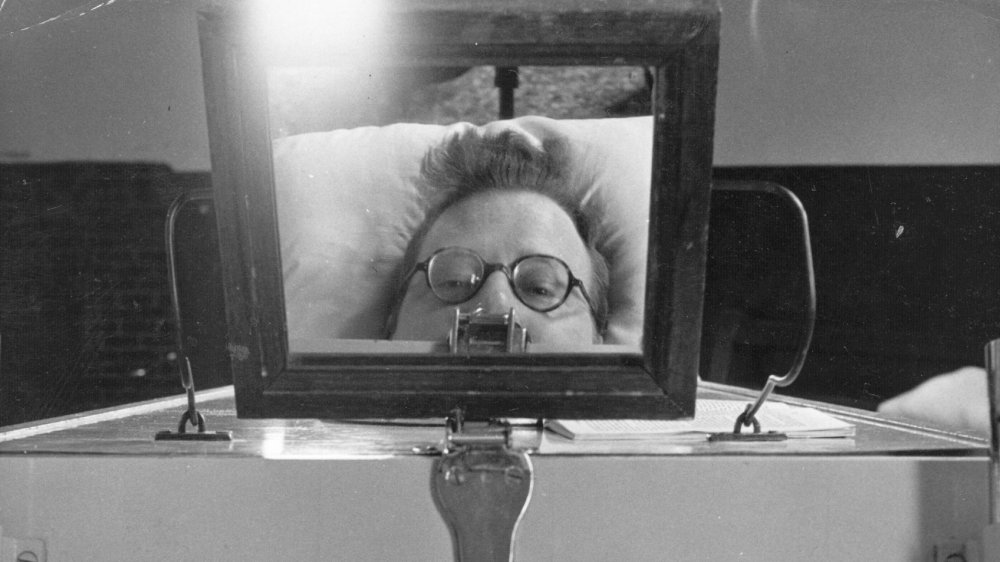 1949: A mirror placed on top of his Iron Lung enables Mr Evans a paralysis sufferer to see who is entering his room