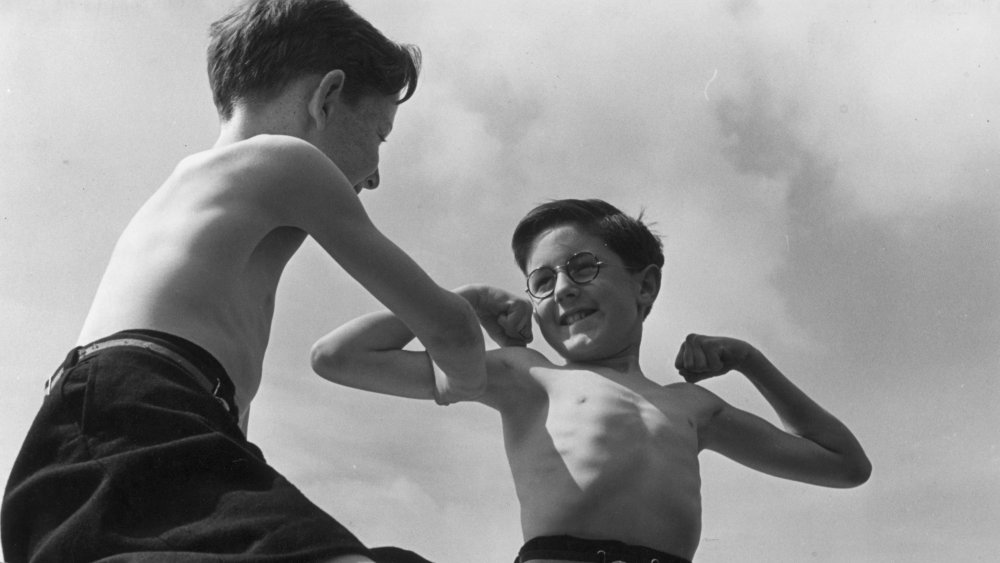 1942: Two boys comparing their muscles at a sanatorium for tuberculosis