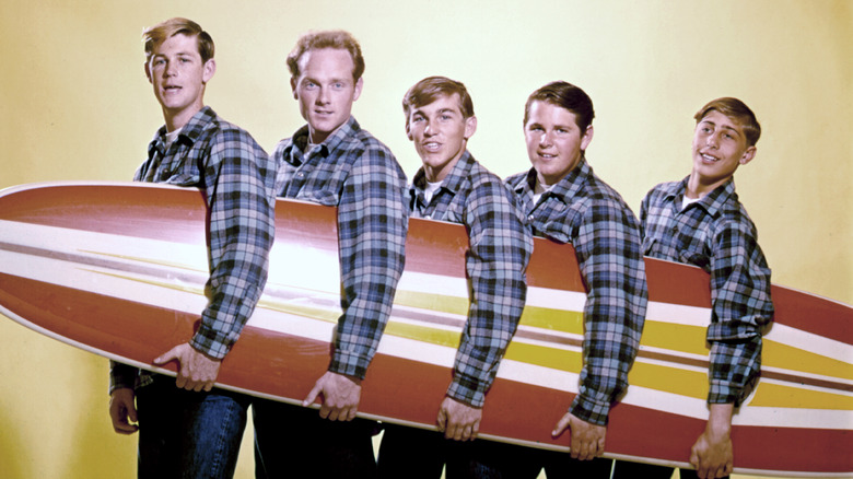 beach boys holding surf board 1960s