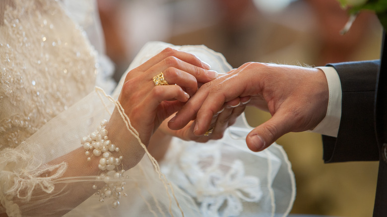 Bride and groom exchanging rings