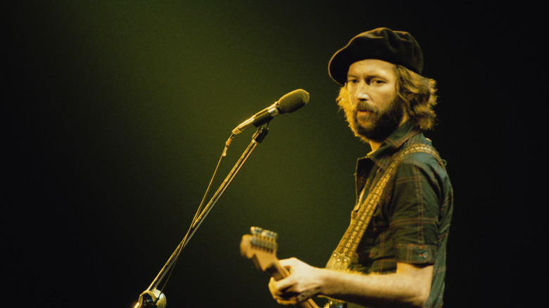 Eric Clapton wearing a beret while performing