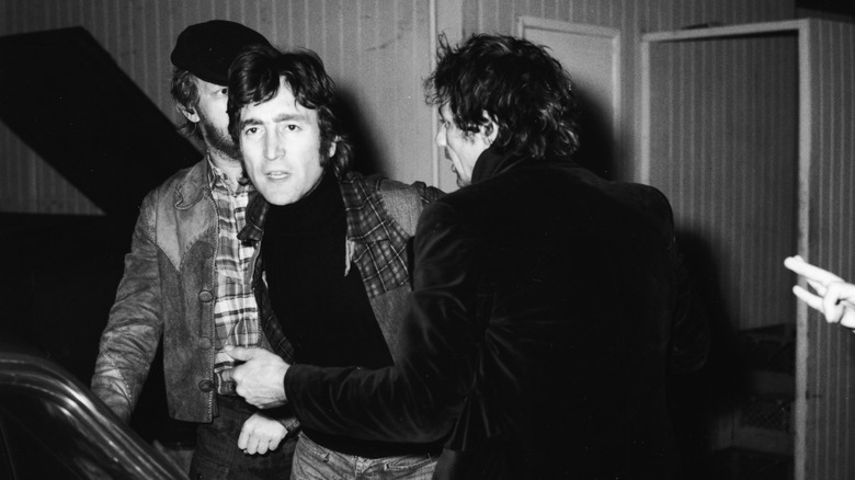 John Lennon being held back from fighting someone at the Troubadour
