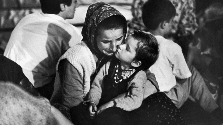 Muslim woman holding child crying