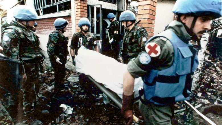 UN peacekeepers carrying body on stretcher