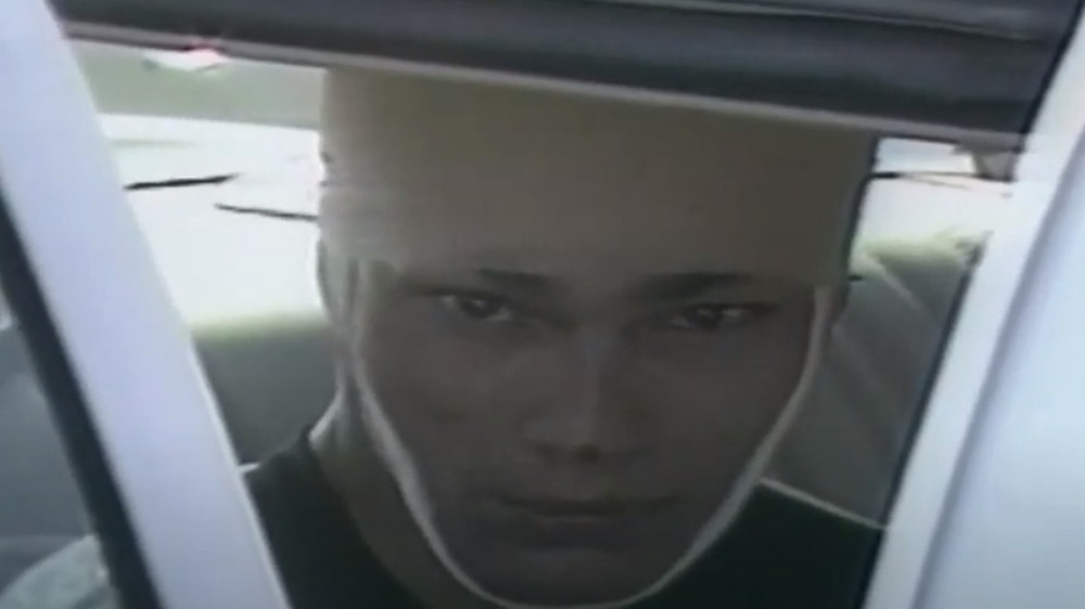 A bandaged Richard Ramirez is taken into custody