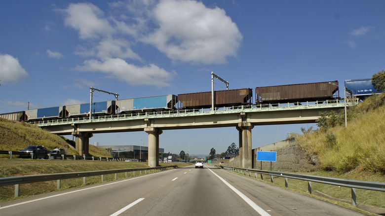 A freight train passes over a bridge