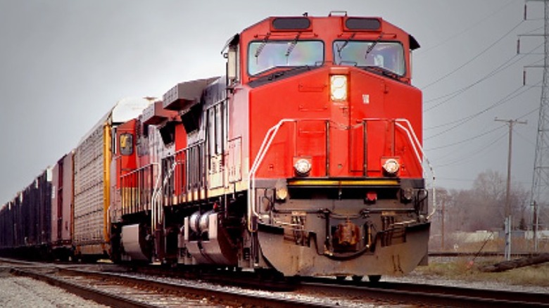 A freight car passes by power lines