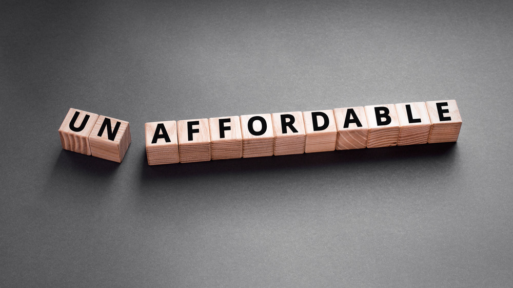 Scrabble blocks spelling "un-affordable"