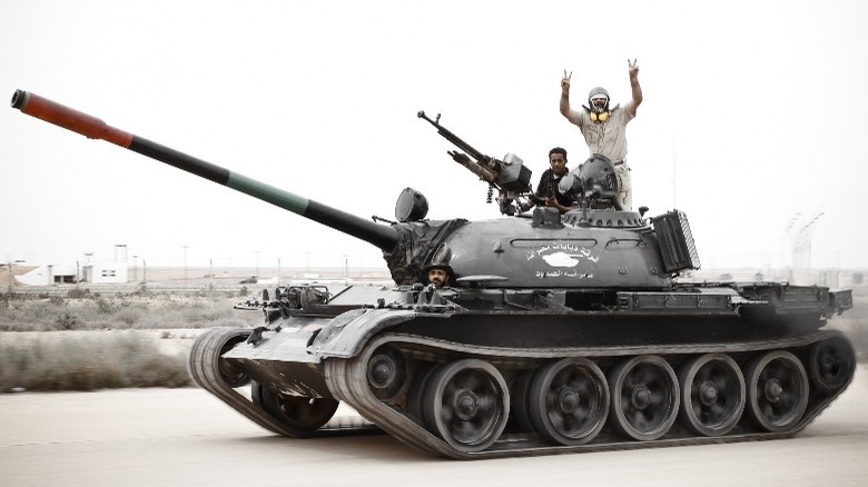 Libyan soldiers riding in armored vehicle