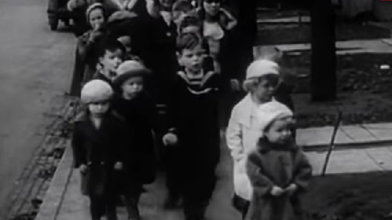 Children lining up on sidewalk