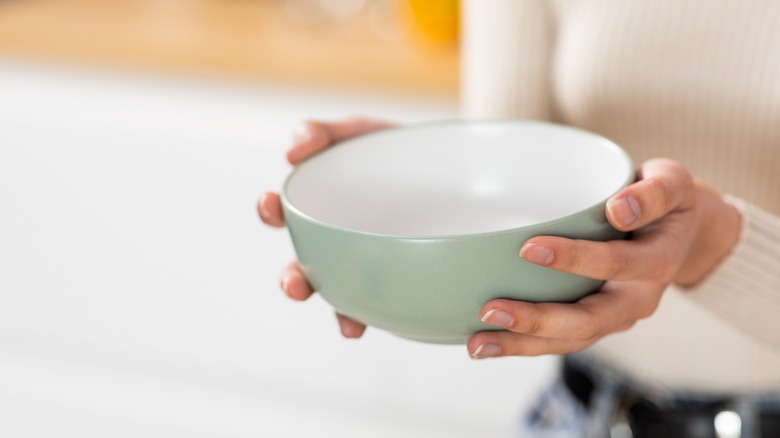 hands holding empty bowl
