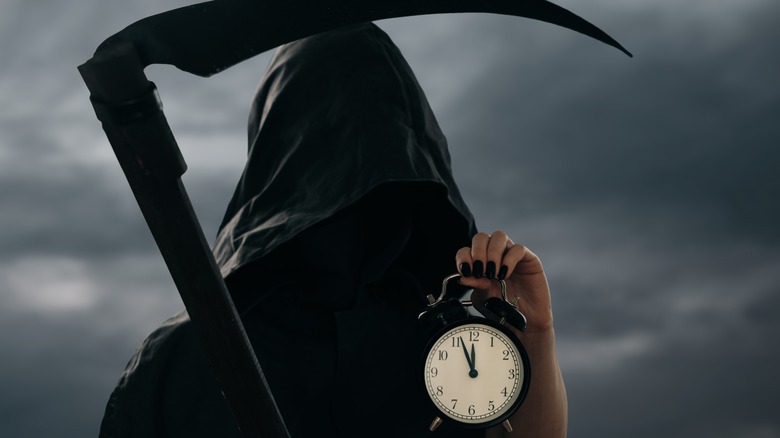 Grim Reaper holding scythe and clock