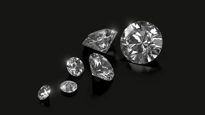 Multiplel cut diamonds on black background.