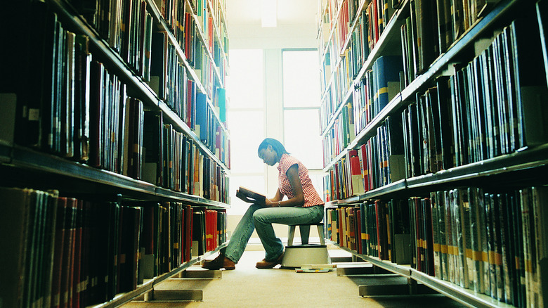 School library aisle girl reading