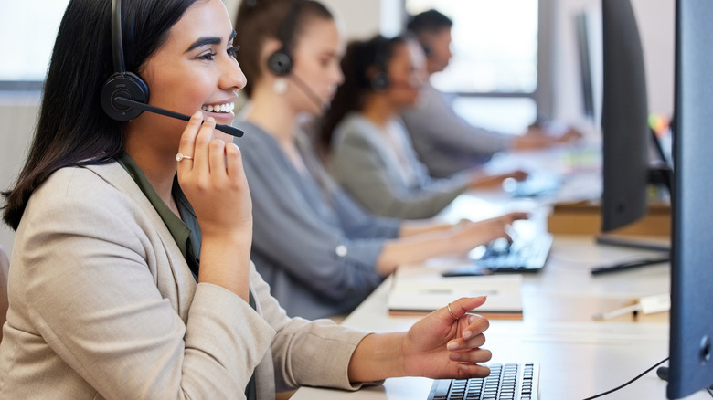 A row of happy customer support agents