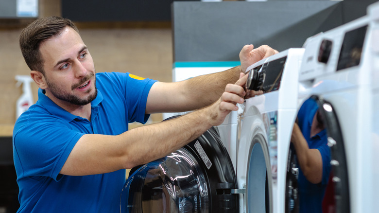 A sales rep demonstrating washing machine functions
