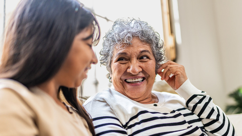A grandmother and granddaughter happily talking