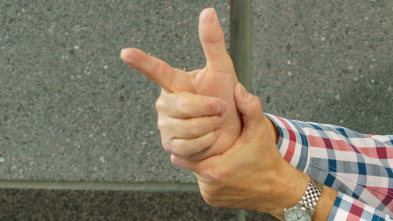 A man pointing finger guns