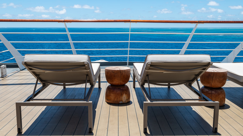 Empty chairs overlooking the ocean on a cruise ship