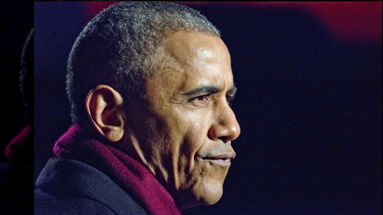 Side view of ex-U.S. President Barack Obama grimacing