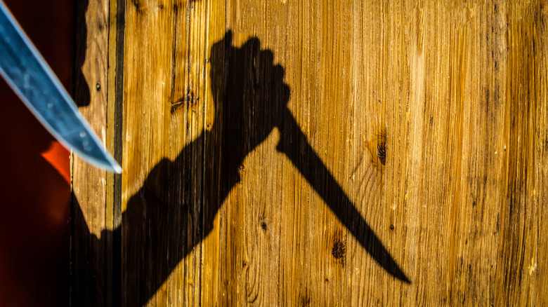 shadow of a killer with knife
