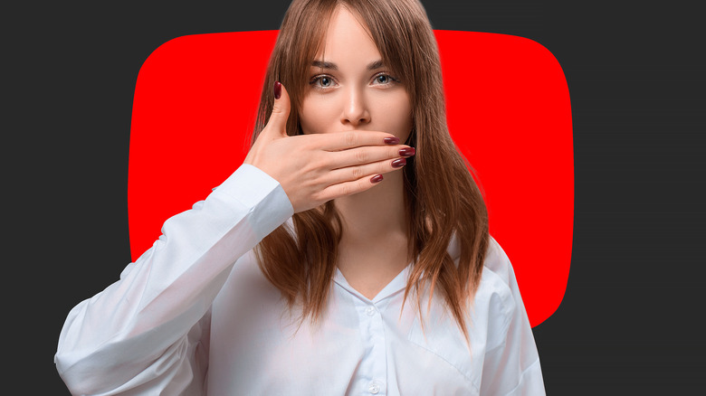 woman holding her hand to silence herself