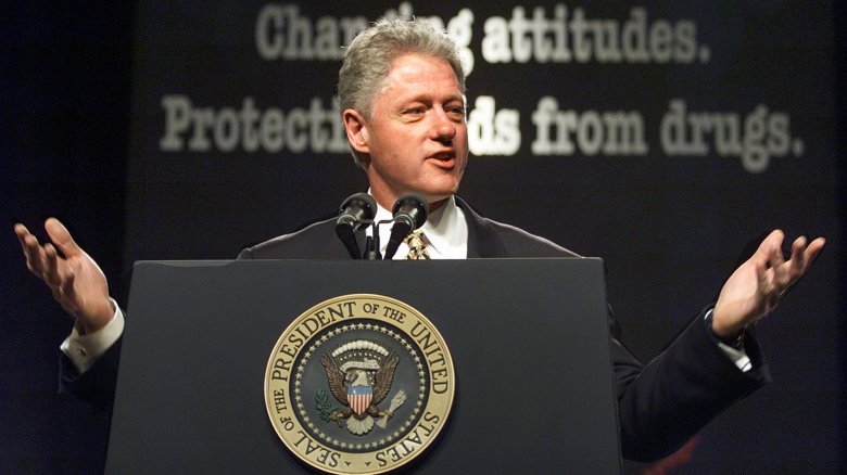 Bill Clinton arms raised delivering speech on stage