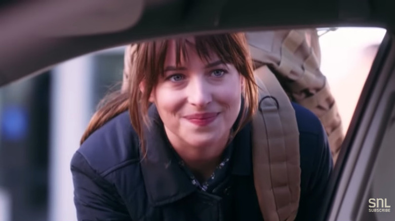 Dakota Johnson backpack leaning into car window