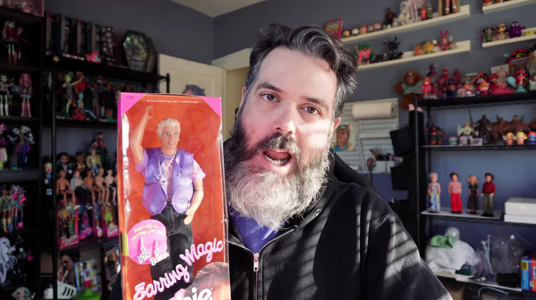 screenshot of video of collector discussing earring magic ken