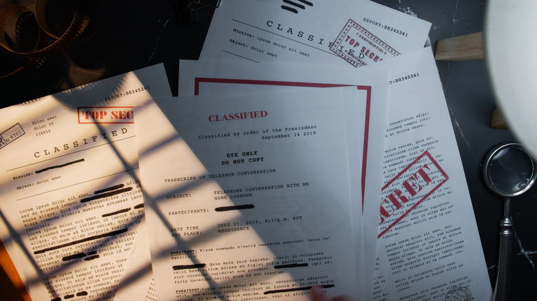Documents with top secret and classified stamps.