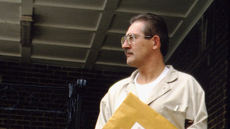 Aldrich Ames arriving for trial in 1994, holding documents.