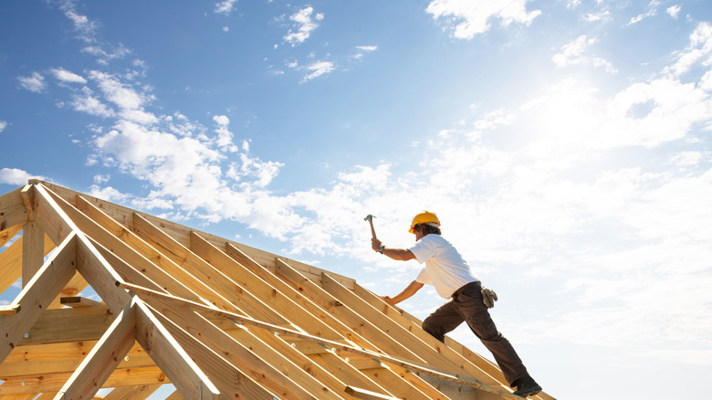 Professional roofer in his working environment