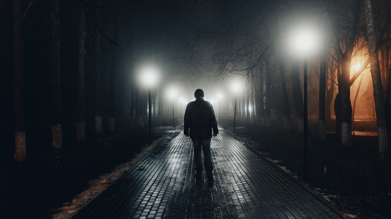 man dark alley white lights