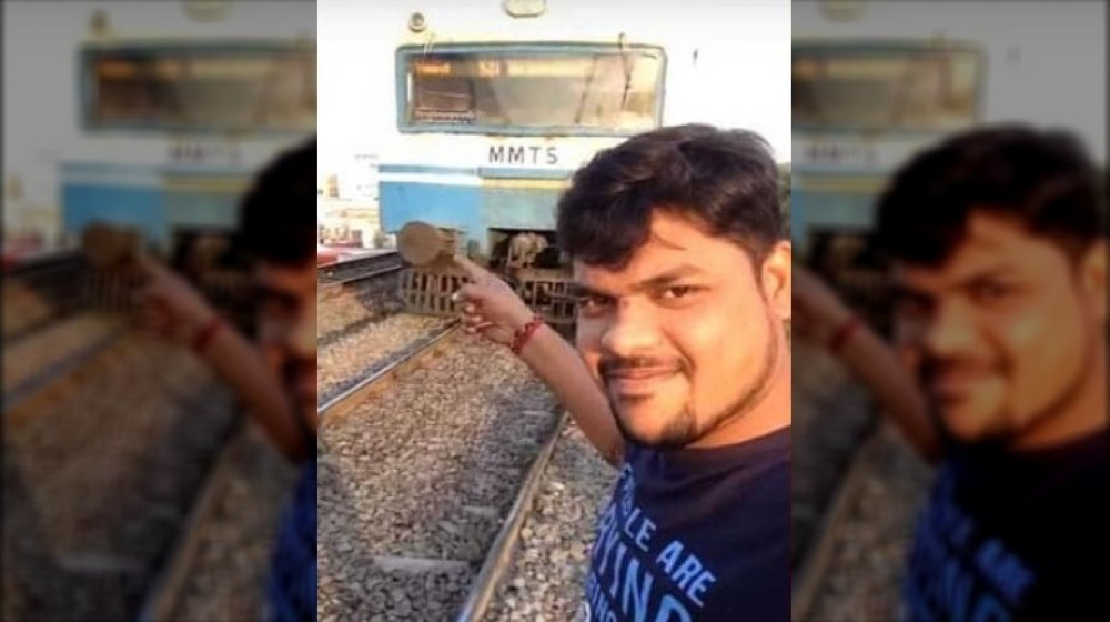 dangerous social media photo, man with train