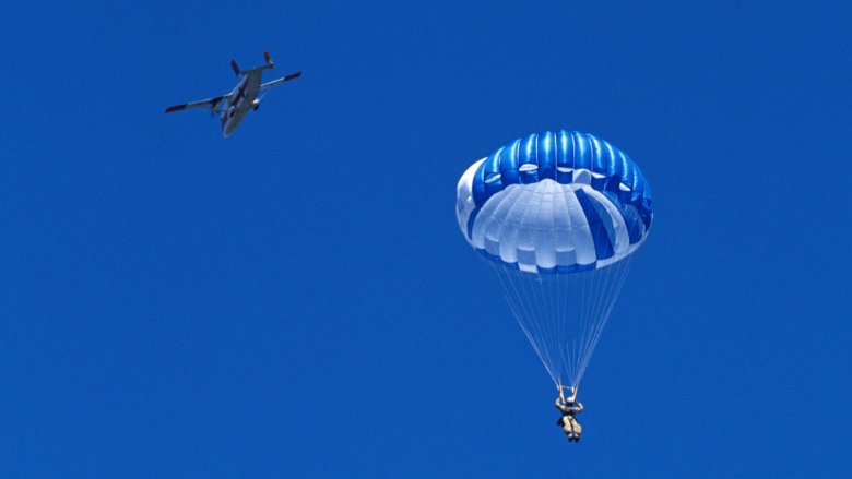 smokejumper blue parachute plane to the left