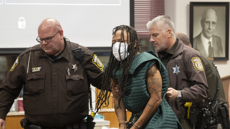 Handcuffed Darrell brooks with mask escorted by police in court