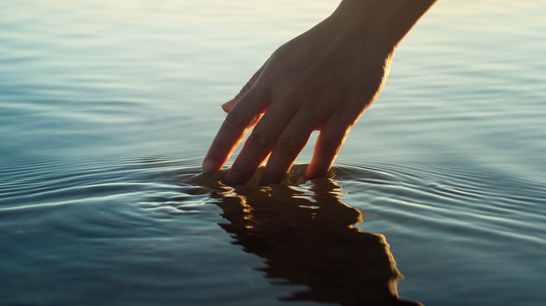 Hand touching water