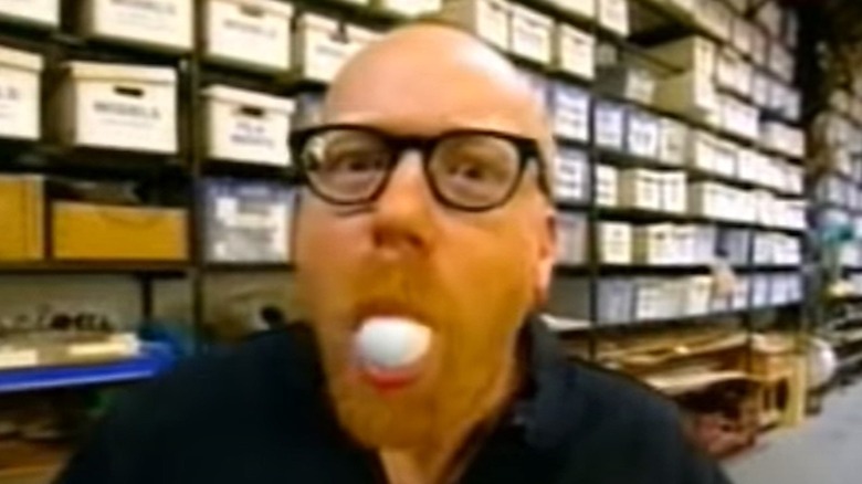 Adam puts ping pong ball in mouth