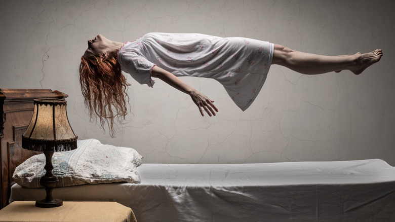 woman in white dress levitating