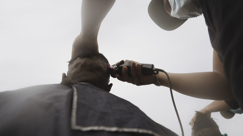 Haitian migrant receiving haircut, Ciudad Acuña
