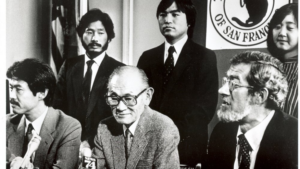 Fred Korematsu, center, sits with with members of his coram nobis legal team 