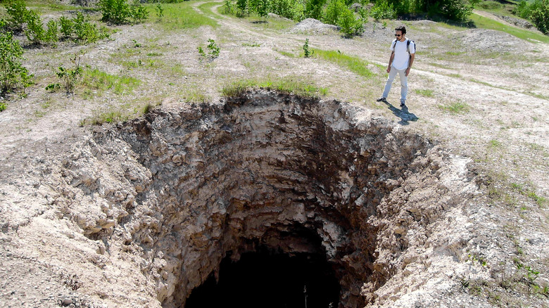 a man by a sinkhole