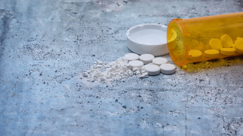 prescription drug bottle with pills spilling out
