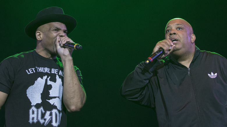 Run-DMC performing mic black shirt jacket and hat