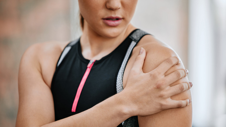 Woman grabbing shoulder