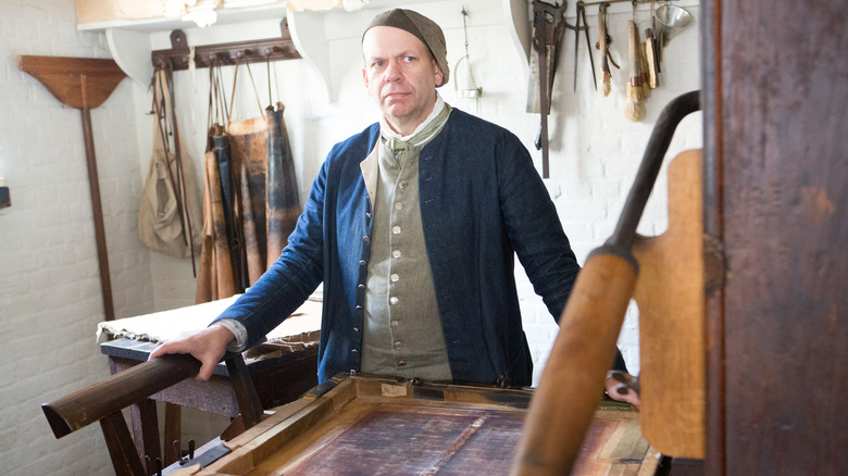 colonial reenactor with printing press