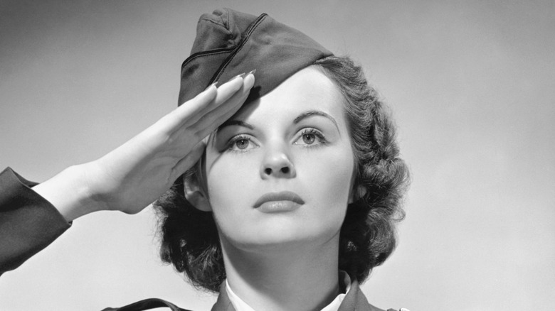 Woman in uniform saluting