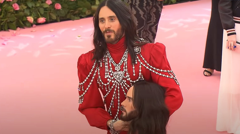 Jared Leto red dress diamonds holding head 