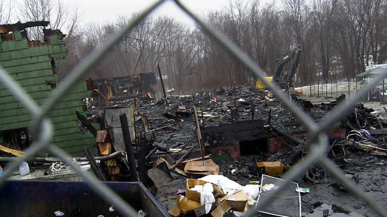 The remains of the Station Nightclub seen through a chain link fence